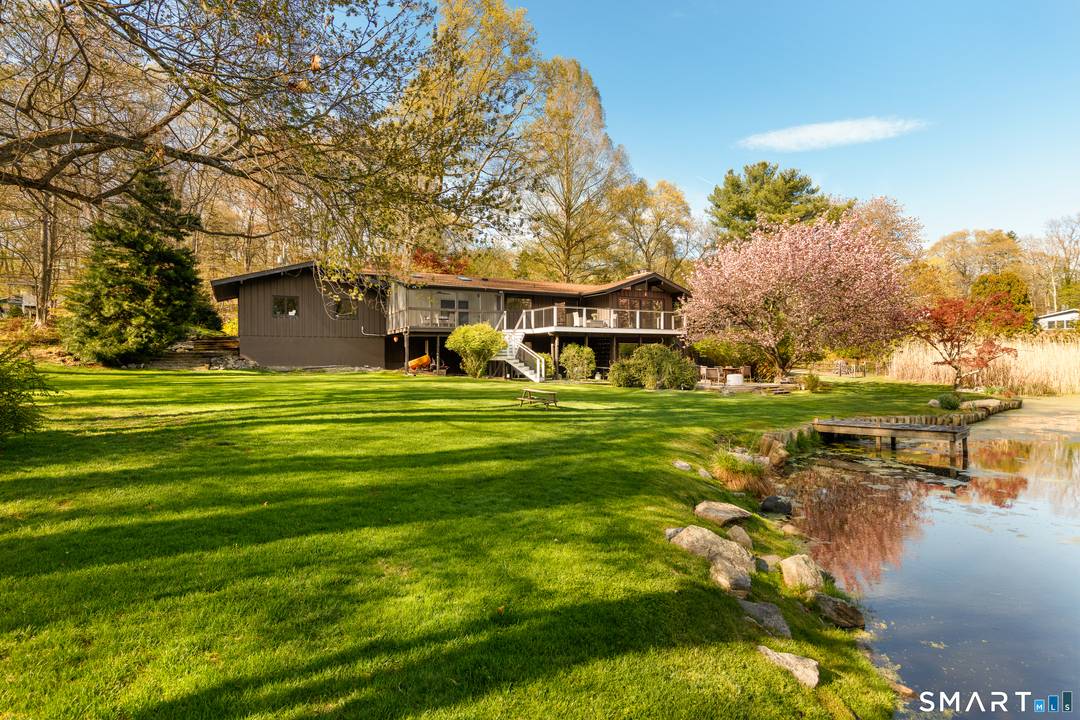 Set in Stamford's coveted north backcountry, this spectacular ranch offers a rare blend of privacy, scale, and serene waterfront living.