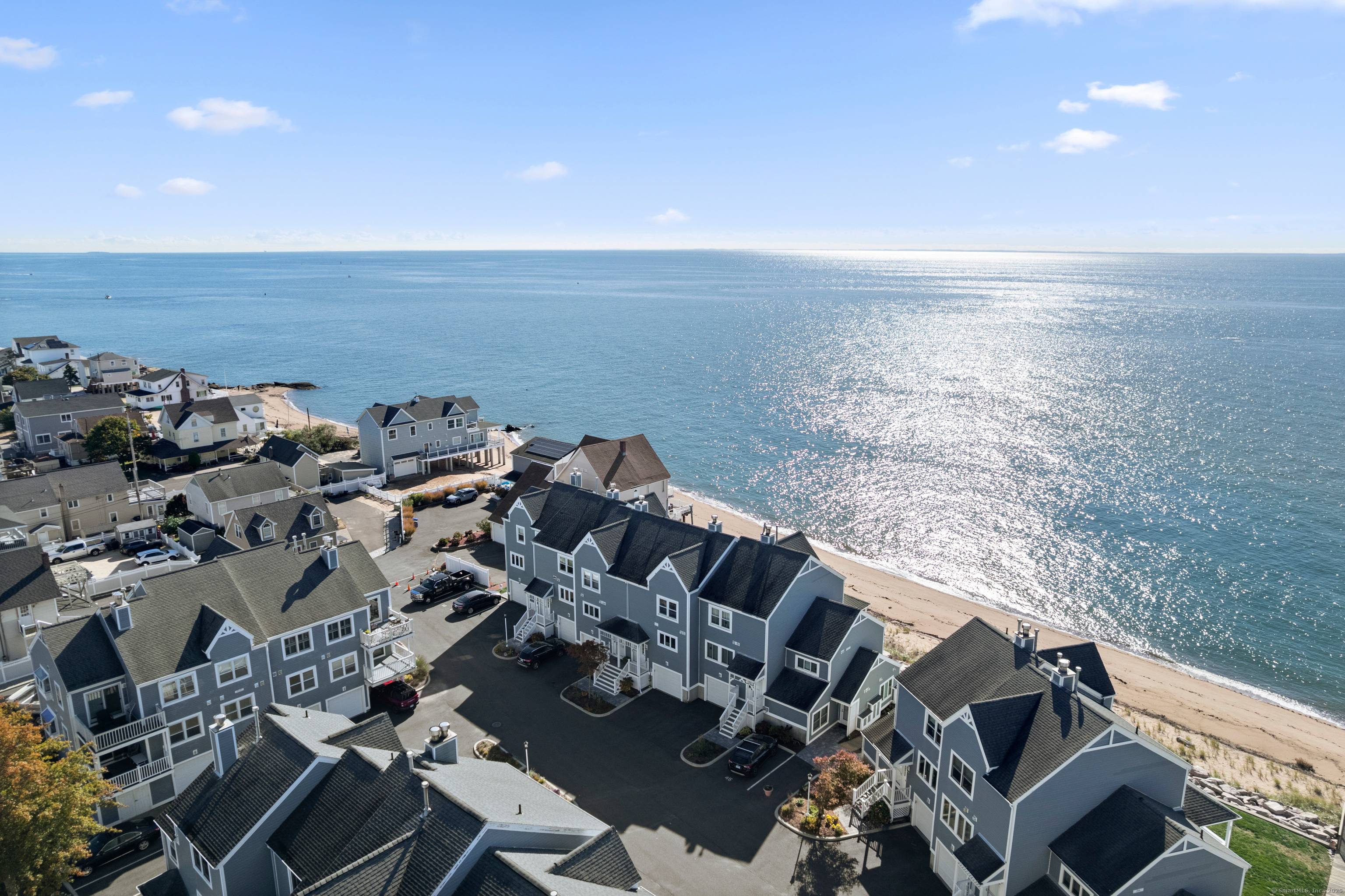 Beautifully renovated waterfront townhouse offering beach access, stunning water views from virtually every room, a versatile bonus room, and an attached garage with additional storage.