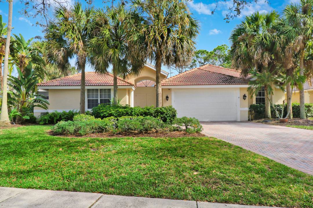 Welcome home to 6995 Cypress Cove Circle, nestled in the serene gated community of Cypress Cove within The Shores of Jupiter.