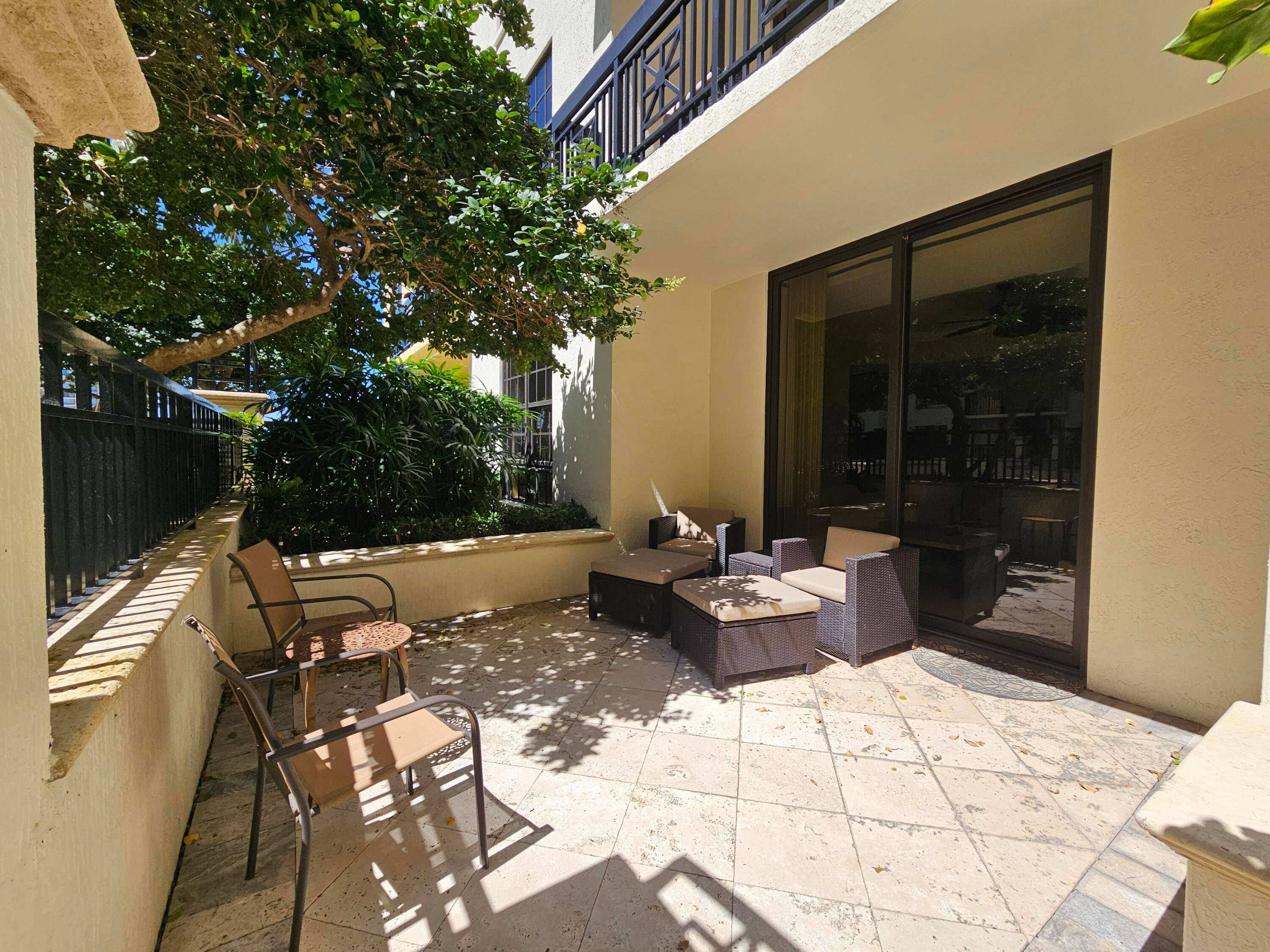 RARE HUGE GATED PATIO Condo on 7th floor looking out at water fountains, palm trees of One City Plaza.