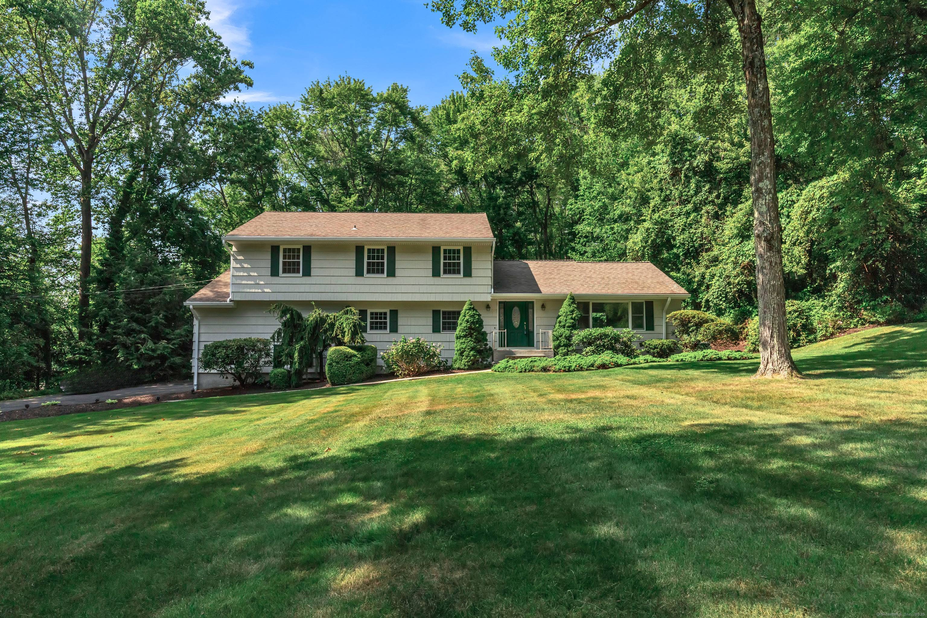 Nestled in one of Trumbull's most desirable neighborhoods, this spacious and professional landscaped home masterfully blends timeless charm with modern comfort.