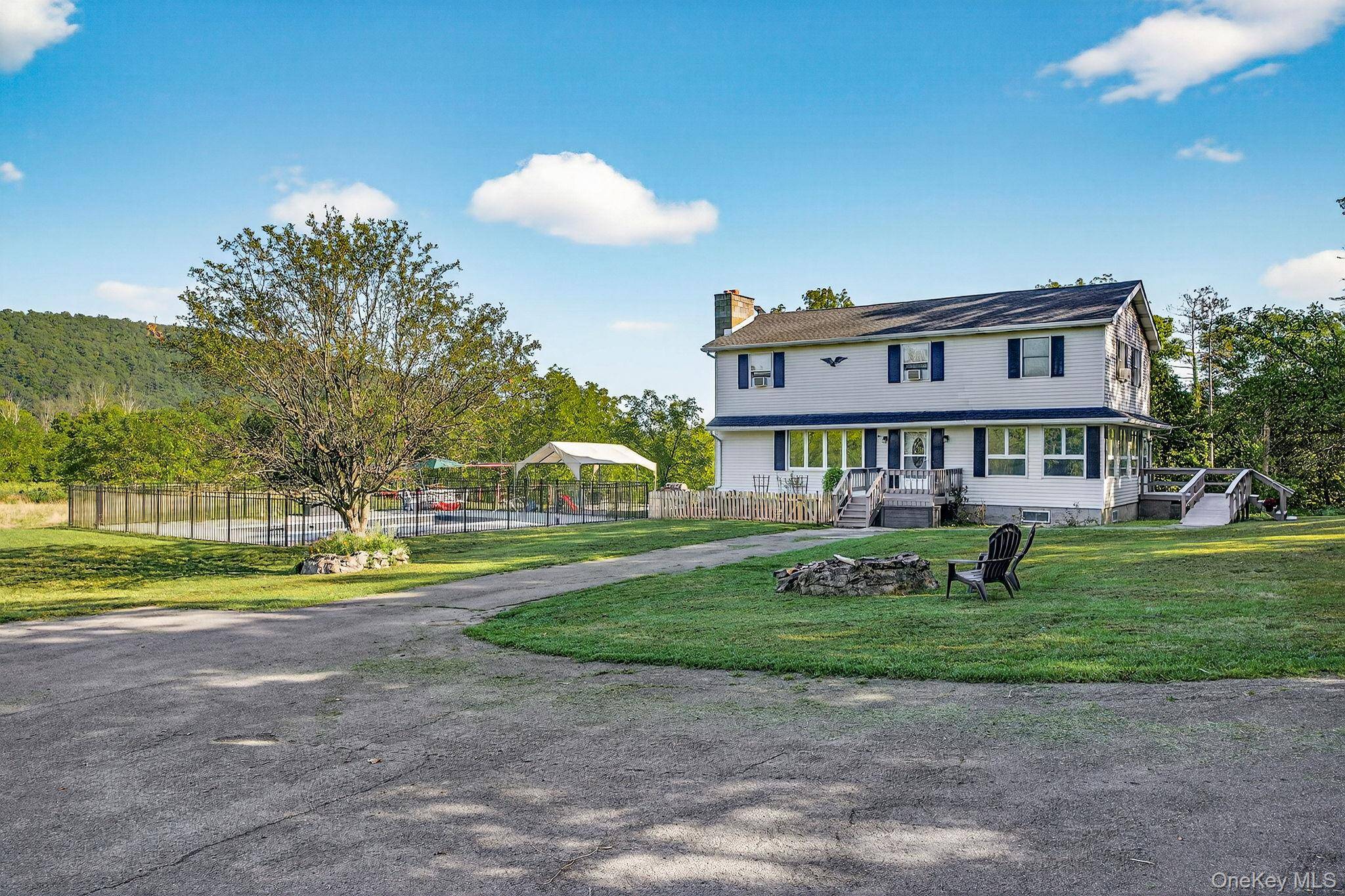 At the very end of an upstate country road, where the pavement turns to gravel and seems to surrender to the land, sits a home that feels like it was ...