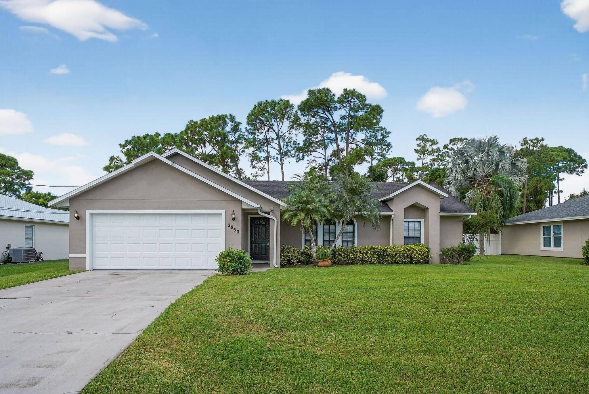 Gorgeous 3 bedroom 2 bathroom home with a 2 car garage, beautiful, updated interior, split floor plan, and a luscious, green, blank canvas of a backyard ready for personal touches.