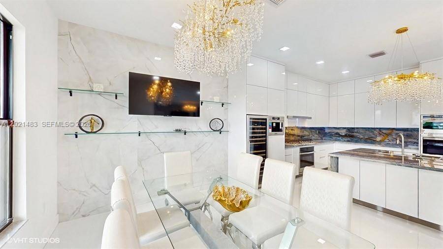 Rare opportunity to purchase a Premium Polynesian Model on the best lakefront lot in Lotus Palm !