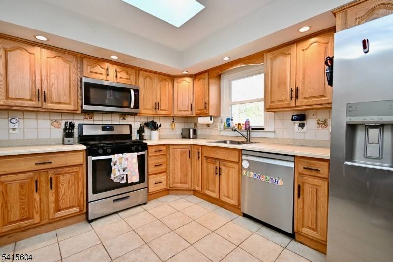 Welcome to 27 Caro Drive nestled on a quiet residential street in the desirable Oak Ridge section of West Milford.