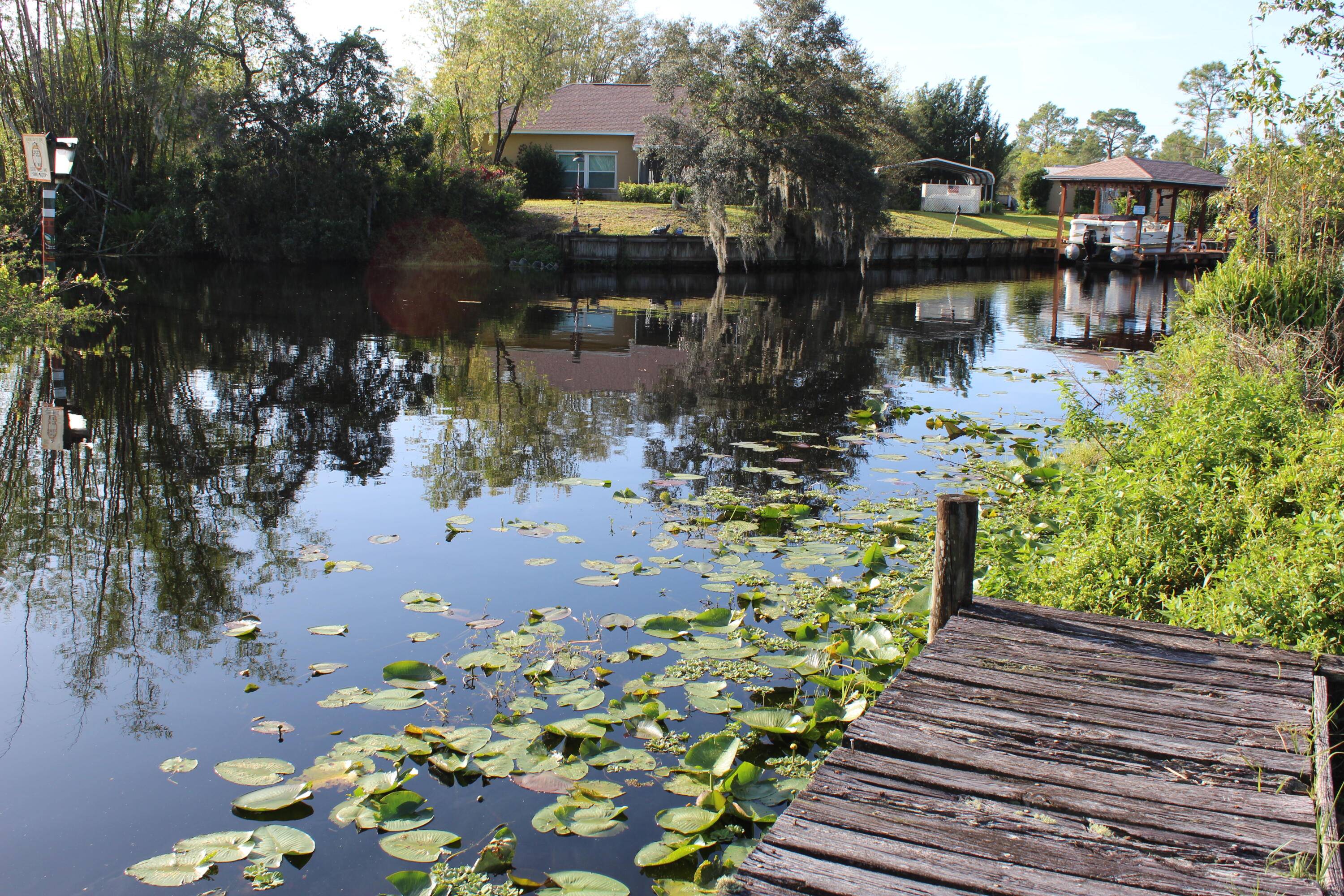 Gorgeous lot is. 3 acre in Leisure Lakes on canal with direct access to Lake Carrie and Lake June.