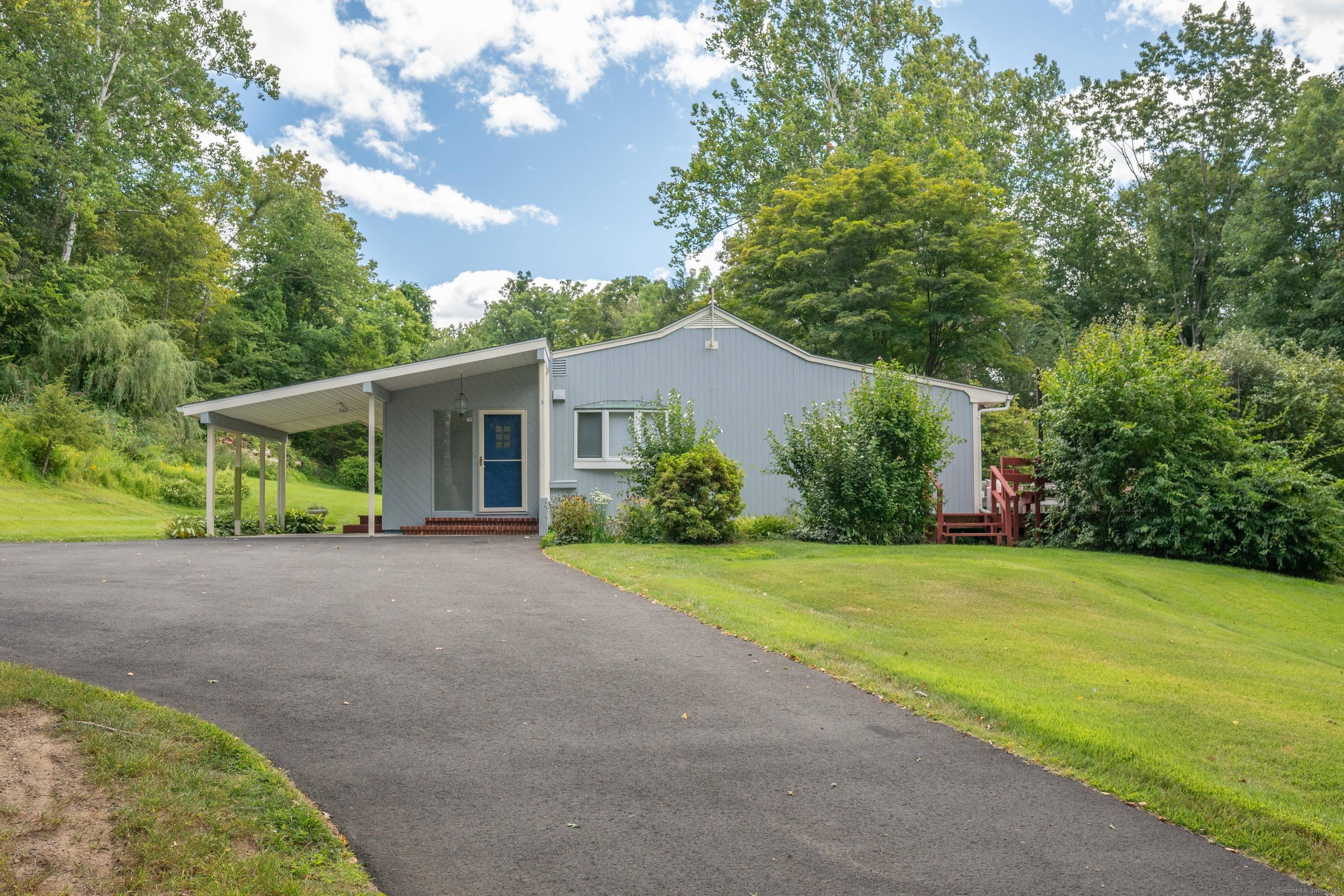Tucked away on a private lot surrounded by woods with views of nature all around, you'll find this lovely Mid Century 3 bedroom Ranch style home.