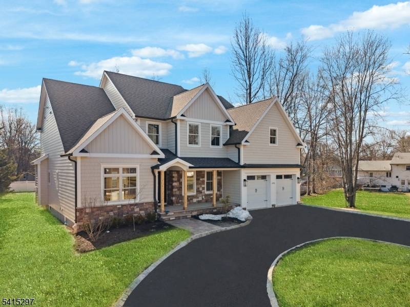 This stunning new construction home perfectly blends luxurious, thoughtful design on a spacious property with a circular drive.