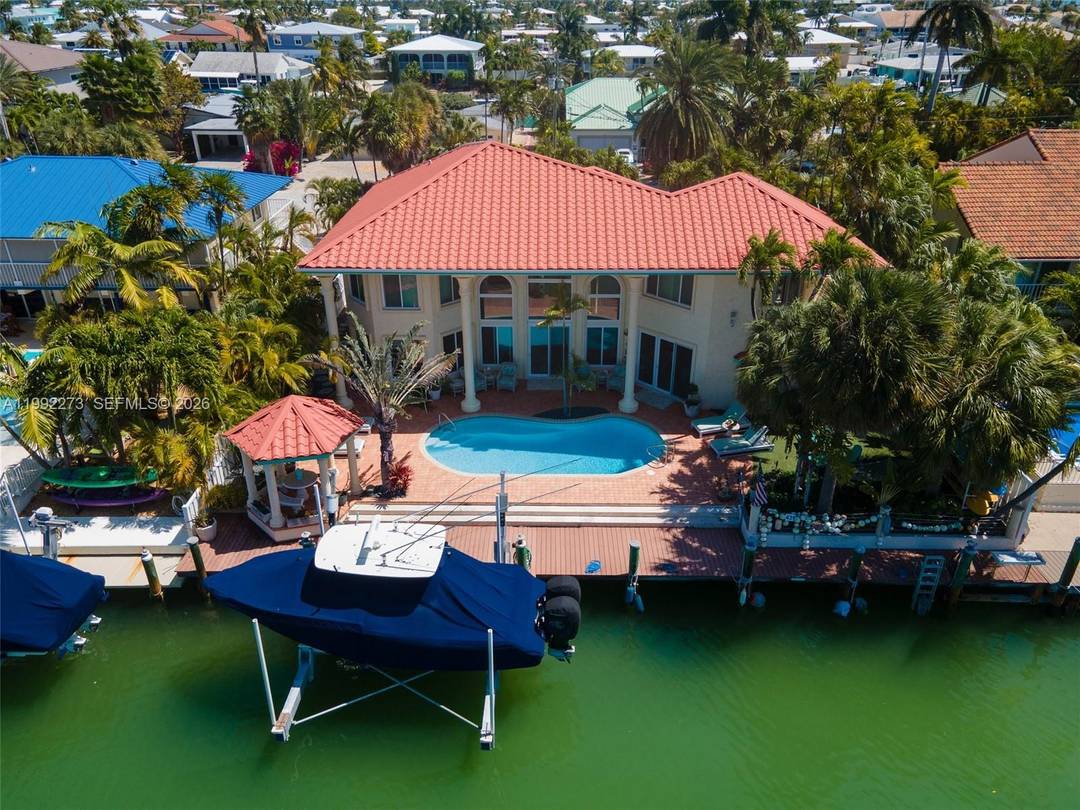 Discover an exceptional D'Asign Source designer home in prestigious Key Colony Beach, set on a beautifully landscaped lot with effortless access to both the bay and the open ocean.