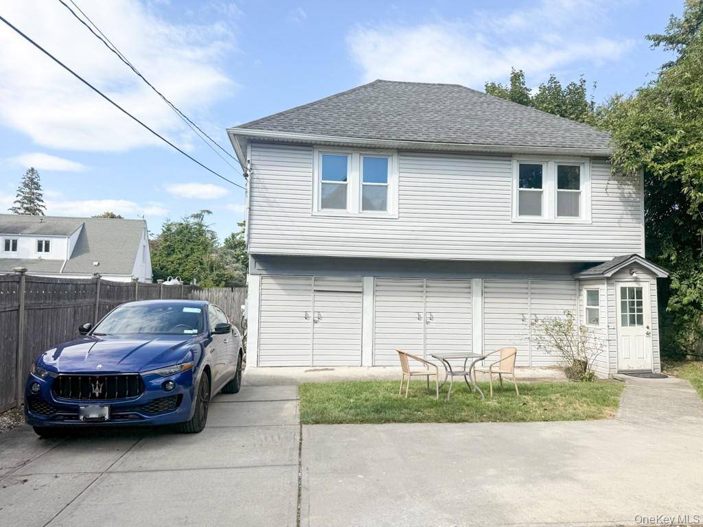 Welcome to 122 Combs Avenue, a charming single family rental in the heart of Woodmere.