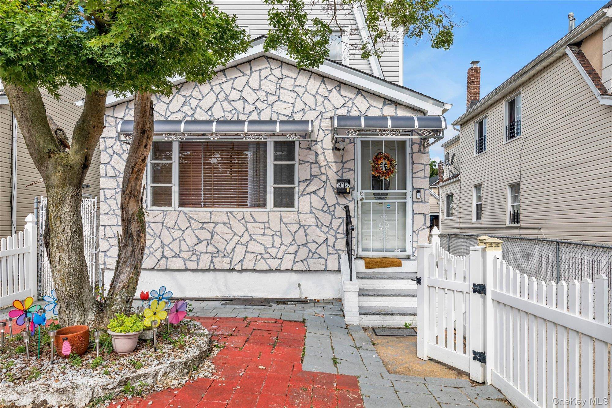 This beautifully updated detached two family home located on a quiet, tree lined block in Springfield Gardens.