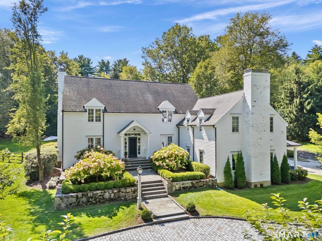 A storybook entrance framed by classic stone walls opens to four flat, park like acres leads you to this thoughtfully updated five bedroom Colonial layered with warmth, character, and the ...