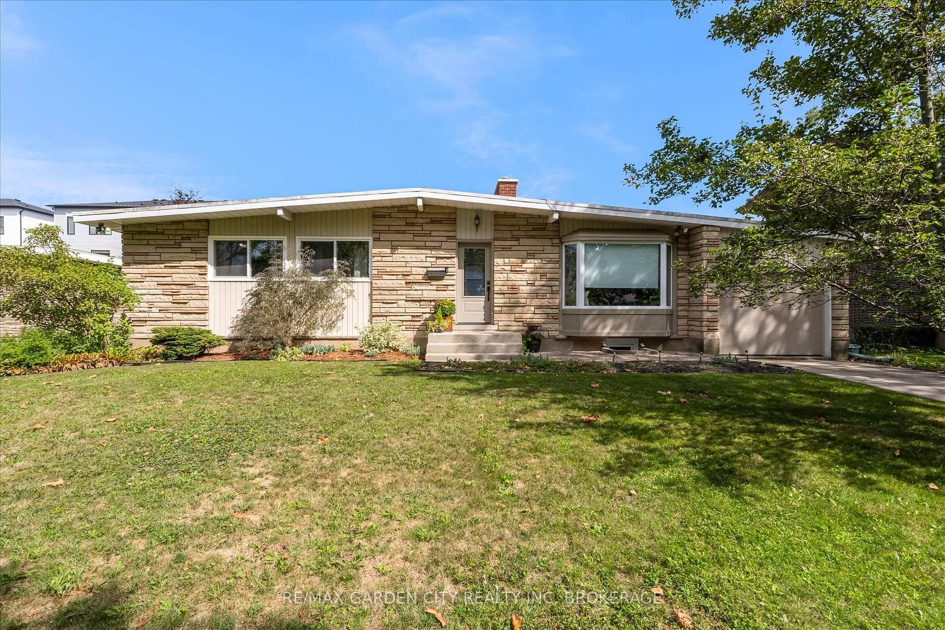 Welcome to this charming 3 2 bedroom, mid century bungalow with attached garage tucked away on a quiet crescent in St.