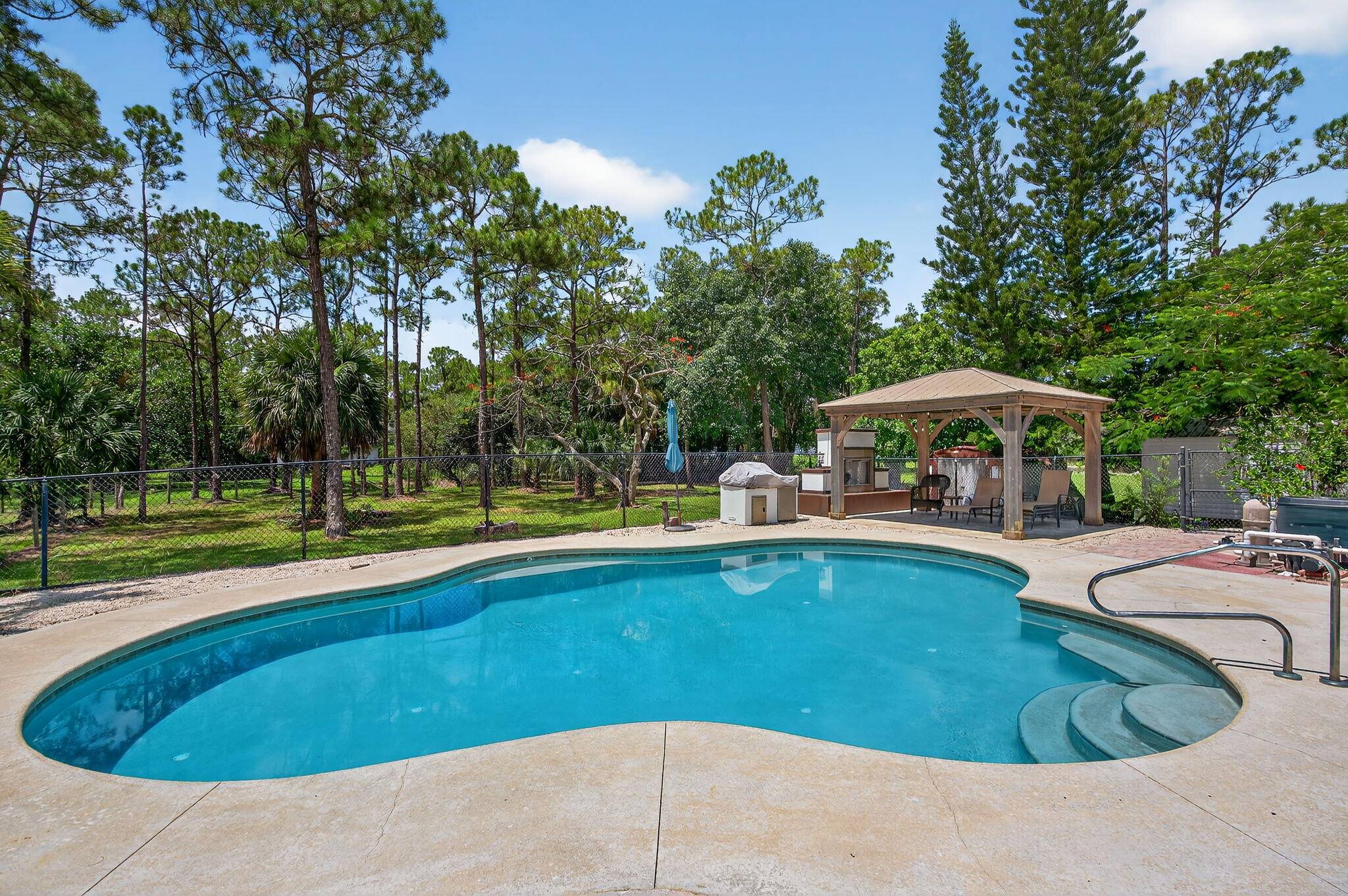 Beautiful, private, 4 3 with a pool, located in the highly sought after Jupiter Farms neighborhood.