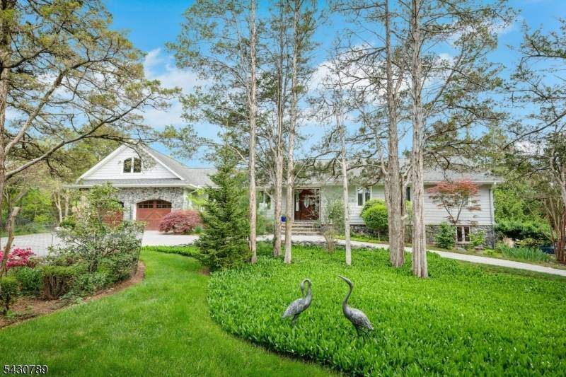 Follow the circular paver driveway to this beautifully appointed granite stone front ranch set on a breathtaking one acre property with sweeping valley views.