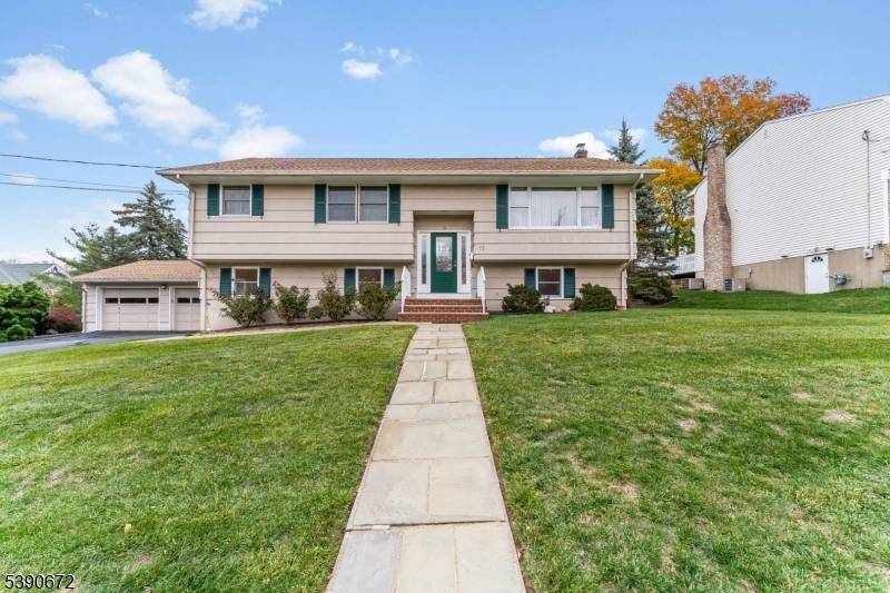 Feel the warmth of this move in ready custom bi level in one of East Hanover's most coveted neighborhoods.