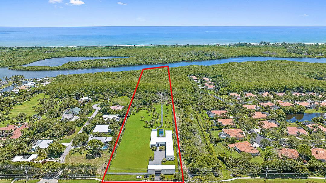 Built in 2022 on over 4 acres, this exceptional property is a dream for car collectors and boaters alike, offering 8 garages with room for lifts and direct Intracoastal access.