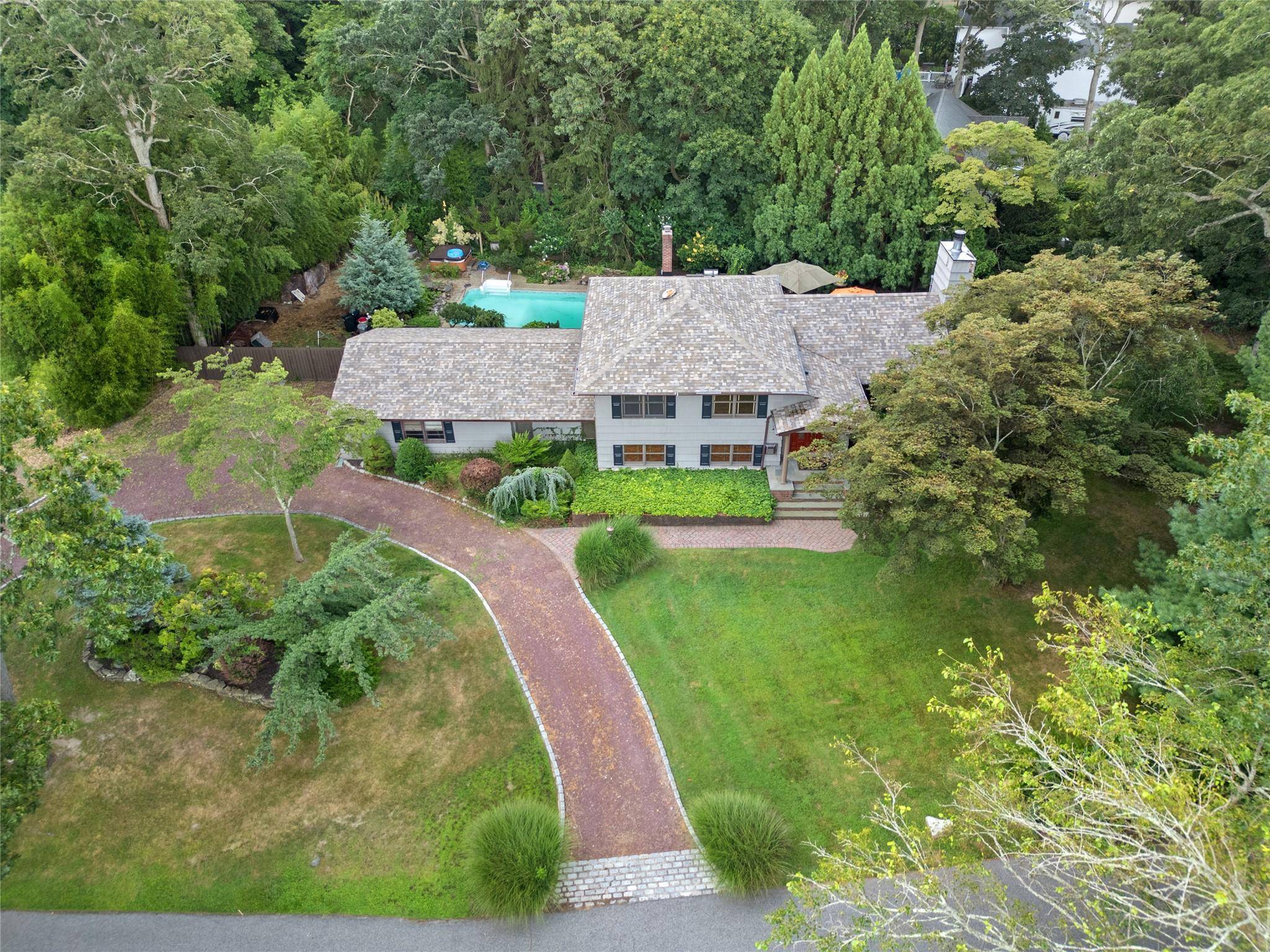 Welcome to this charming and versatile home nestled in one of East Islip s most private and exclusive neighborhoods.