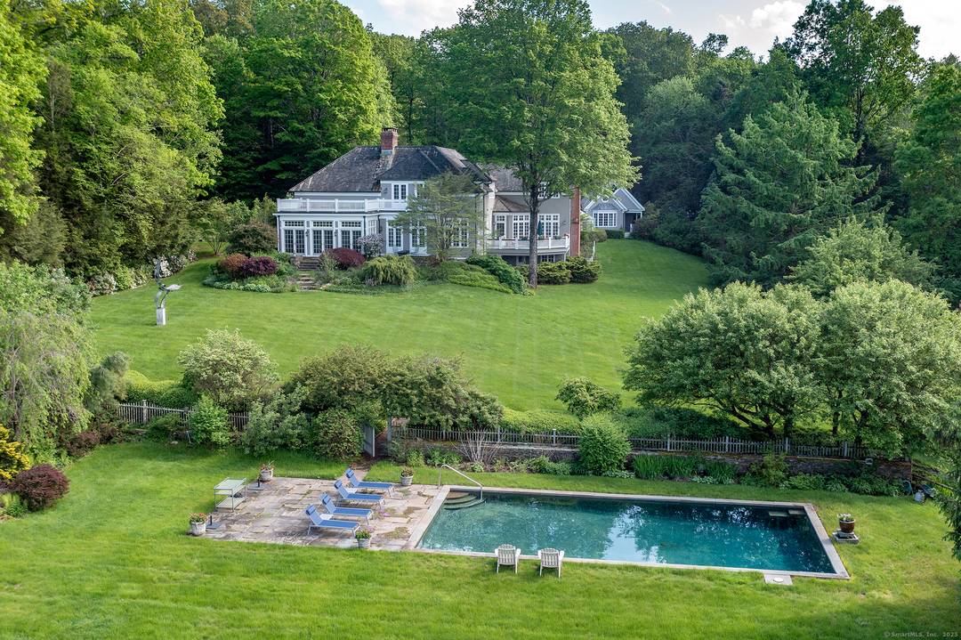 A private gated road leads to this elegant shingle style estate on 20 secluded acres in the beautiful Litchfield Hills with spectacular views that go on for miles.