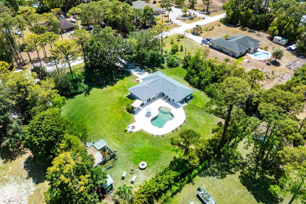 Welcome to this impeccably maintained 3 bedroom, 2 bathroom pool home with a 2 car garage, set on a sprawling 1.