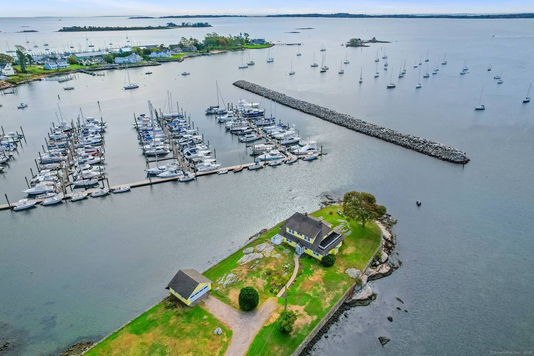 RARE OPPORTUNITY ! Perched proudly on its own peninsula and surrounded by water, this 1920 Dutch Colonial Revival home offers a unique blend of timeless architecture, historic charm, and breathtaking ...