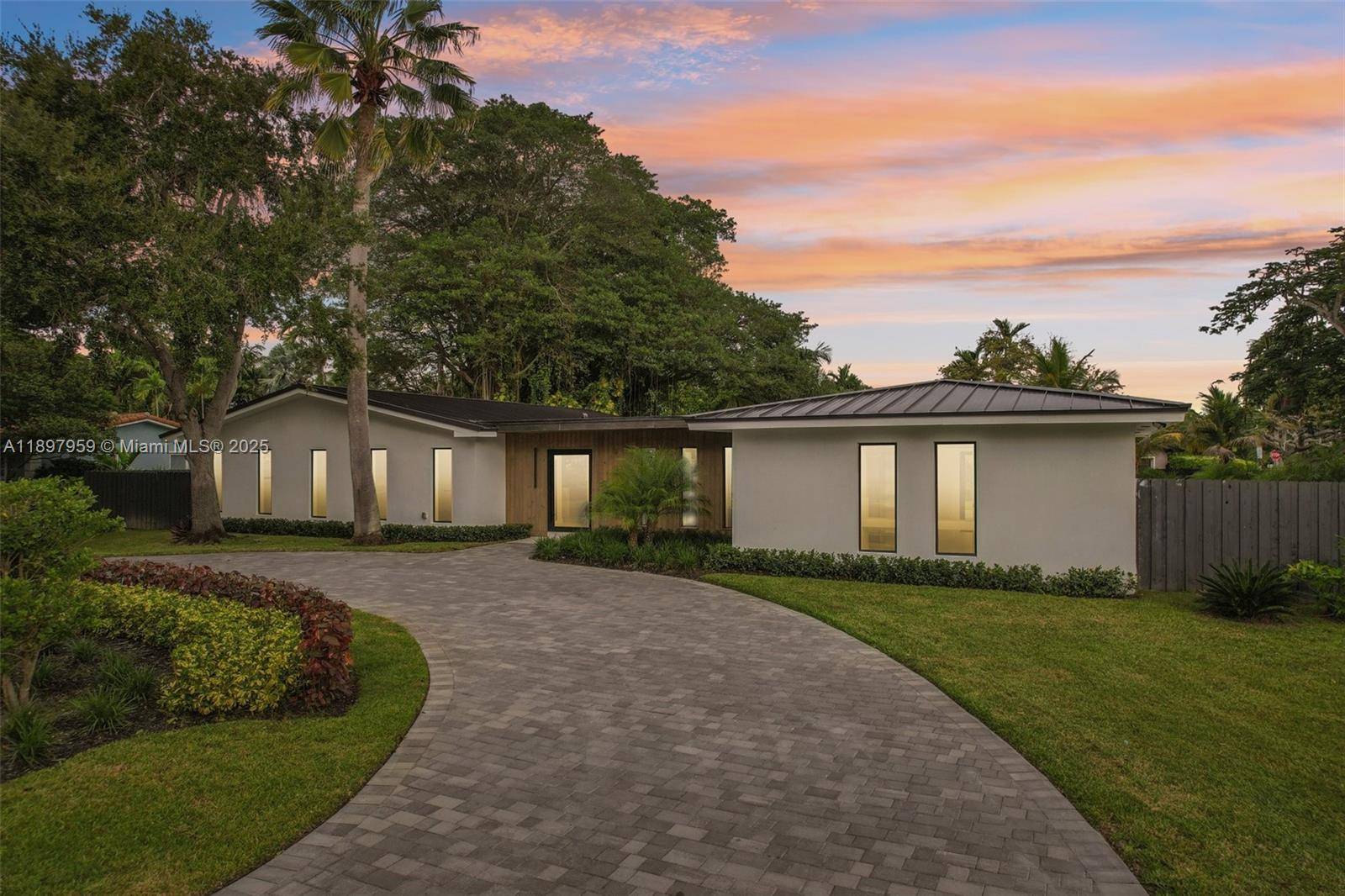 Experience modern luxury and timeless elegance in this stunning 4 bedroom, 3 bath corner lot residence on a spacious 0.