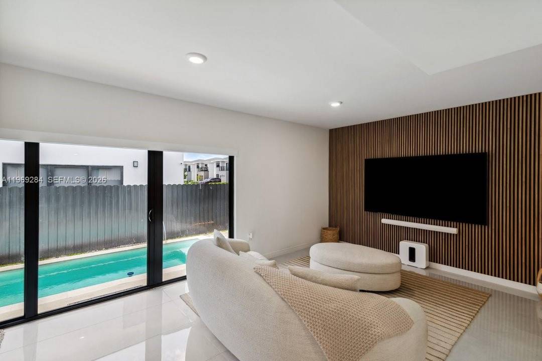 This modern new construction features 5 bedrooms, 3 remodeled bathrooms, impact windows, porcelain tile throughout, and a smart home system.