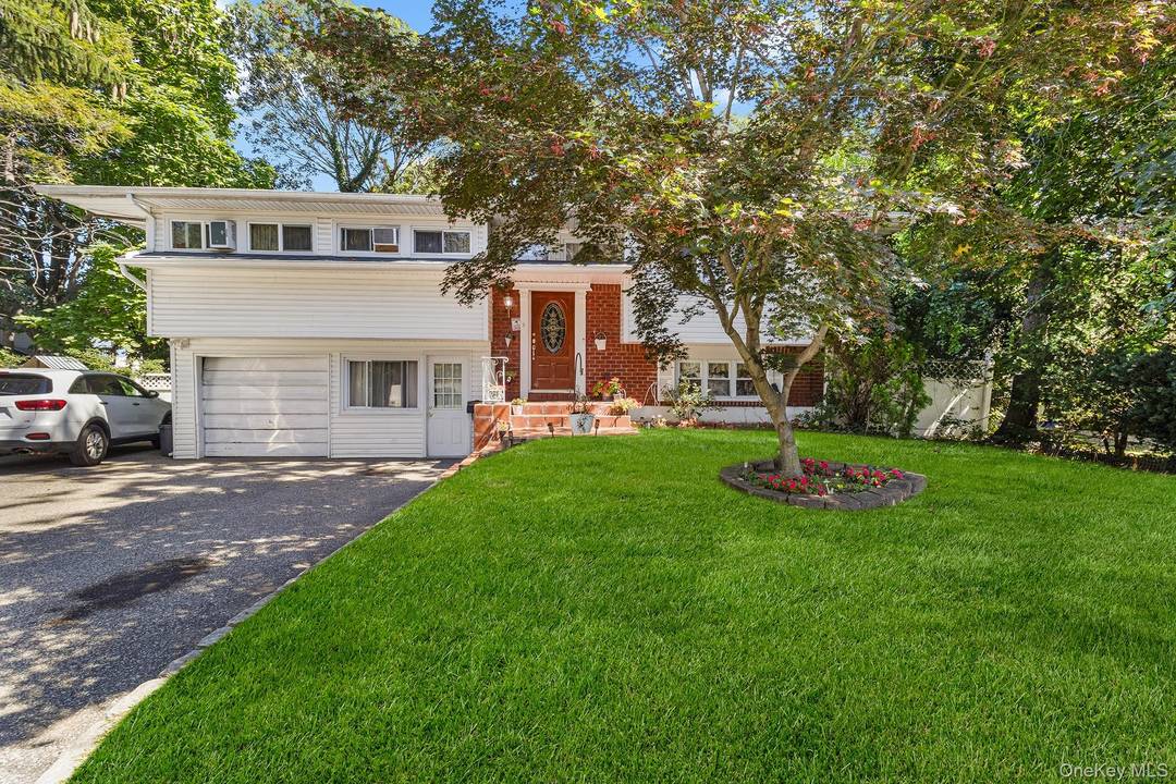 Welcome to 31 Holbrook Rd, a spacious Hi Ranch offering great curb appeal with a classic exterior and an inviting front entry.