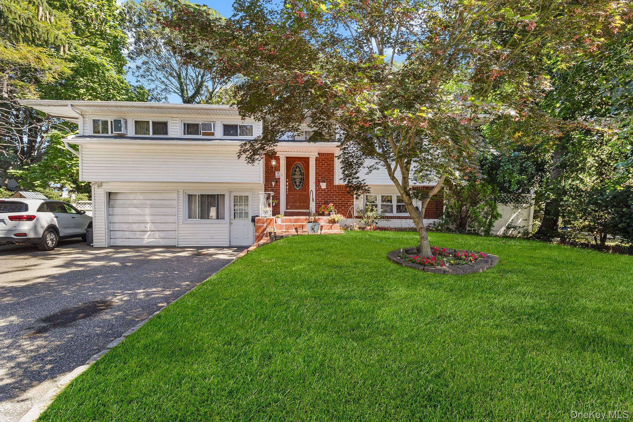 Welcome to 31 Holbrook Rd, a spacious Hi Ranch offering great curb appeal with a classic exterior and an inviting front entry.
