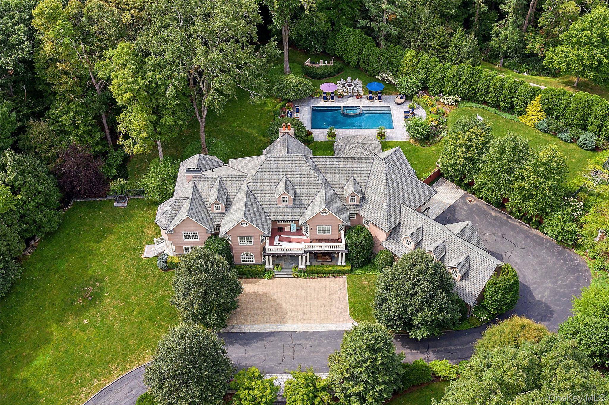 This impressive cedar and stone Colonial is elegantly positioned on an expansive 5 acre, private resort caliber property bordering protected land.