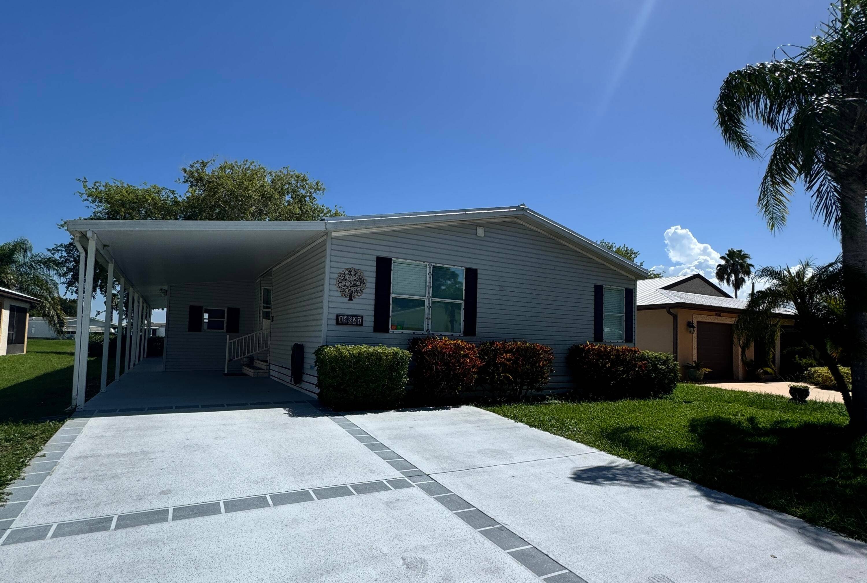 Lovely lake view home in the desirable 55 community of Spanish Lakes Fairways.