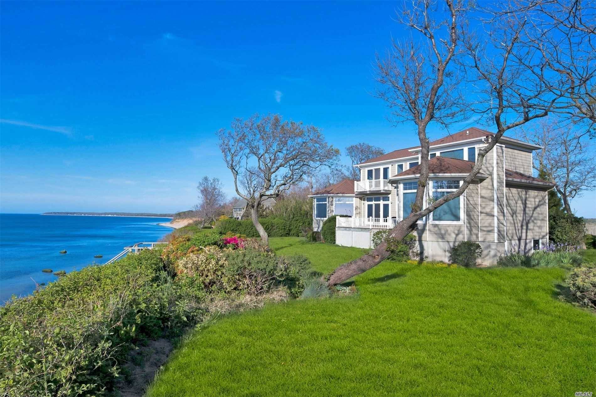 Extraordinary Waterfront Home On Rare One Acre Setting With Mesmerizing Sunsets And Sweeping Vineyard Views.