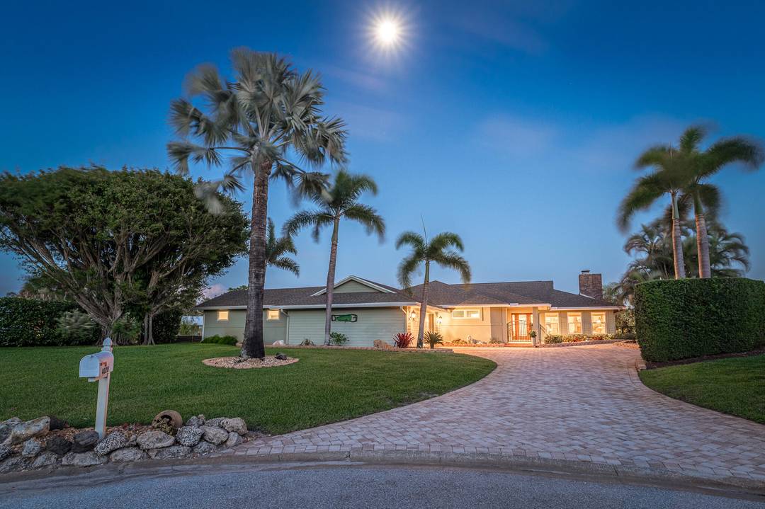 Fully Furnished Turnkey, Beautiful Waterfront Pool Home, hardwood floors, lush landscaping.