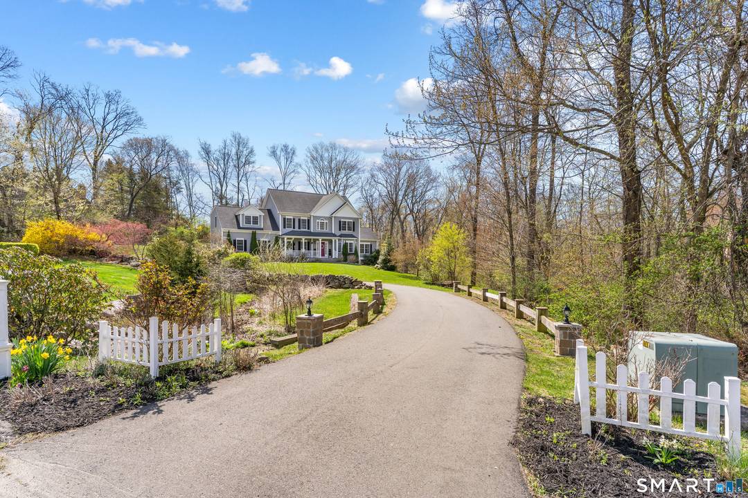 Introducing 24 Fir Tree Drive North, a beautiful residence nestled on over an acre of thoughtfully landscaped grounds.