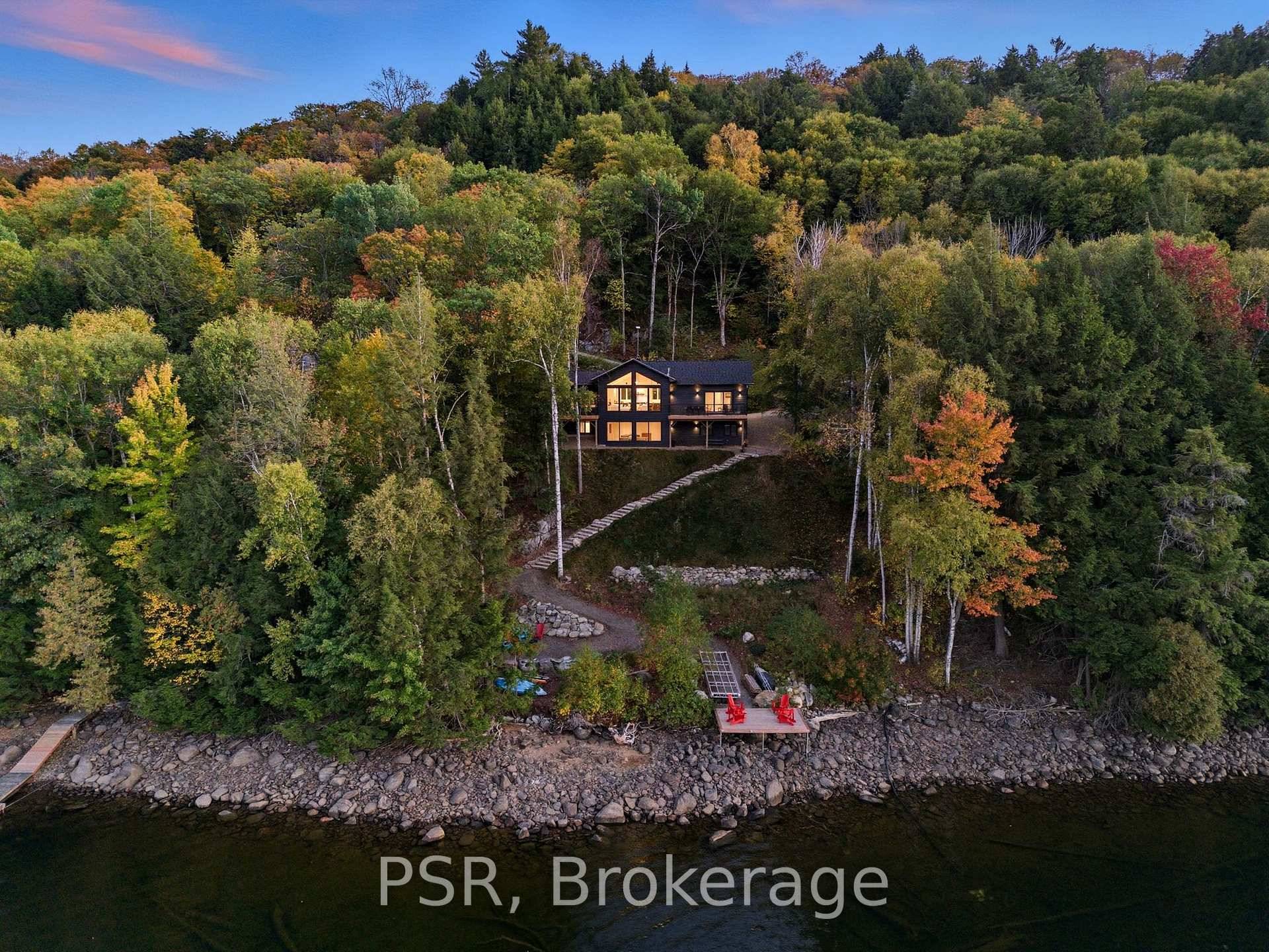 Discover a newly built 2024, turn key cottage with modern design and spectacular lakefront living on Redstone Lake.