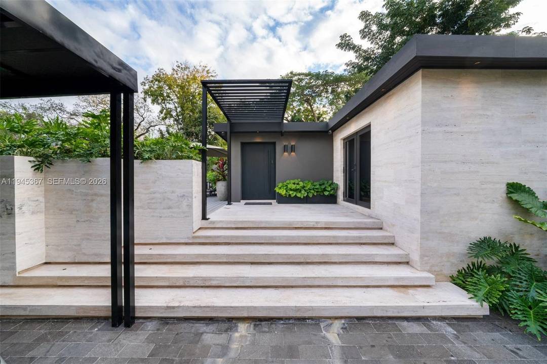 Striking contemporary residence ideally situated in the heart of Coconut Grove, thoughtfully redesigned with an emphasis on quality, design, and privacy.