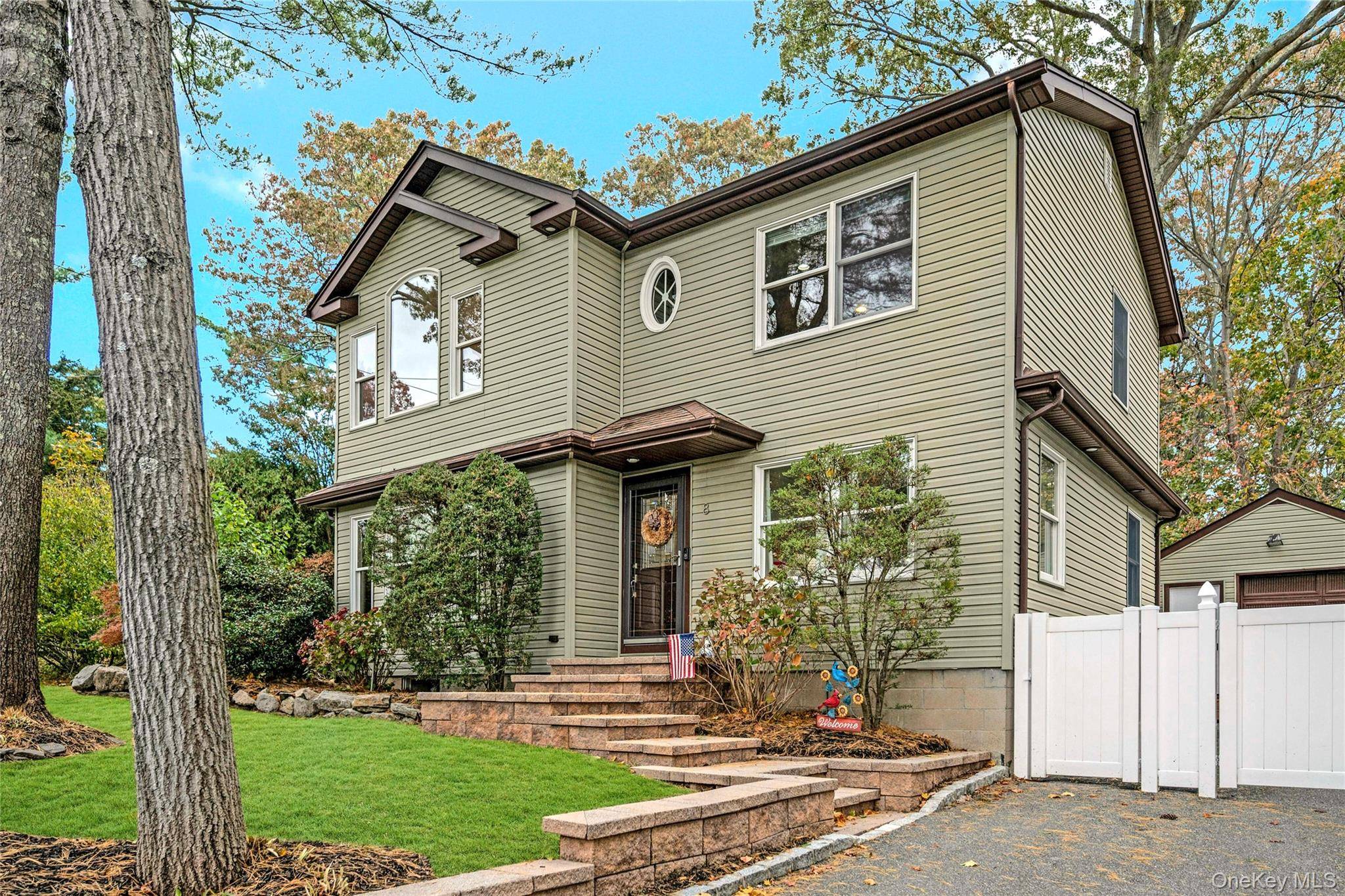 Welcome to this beautifully updated and expanded 5 bedroom, 2 bathroom home nestled on a quiet, tree lined street in desirable Nesconset, within the Smithtown School District.