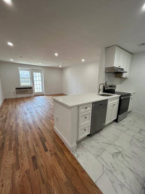 2 Bedroom with hardwood floors balcony, and a parking lot.