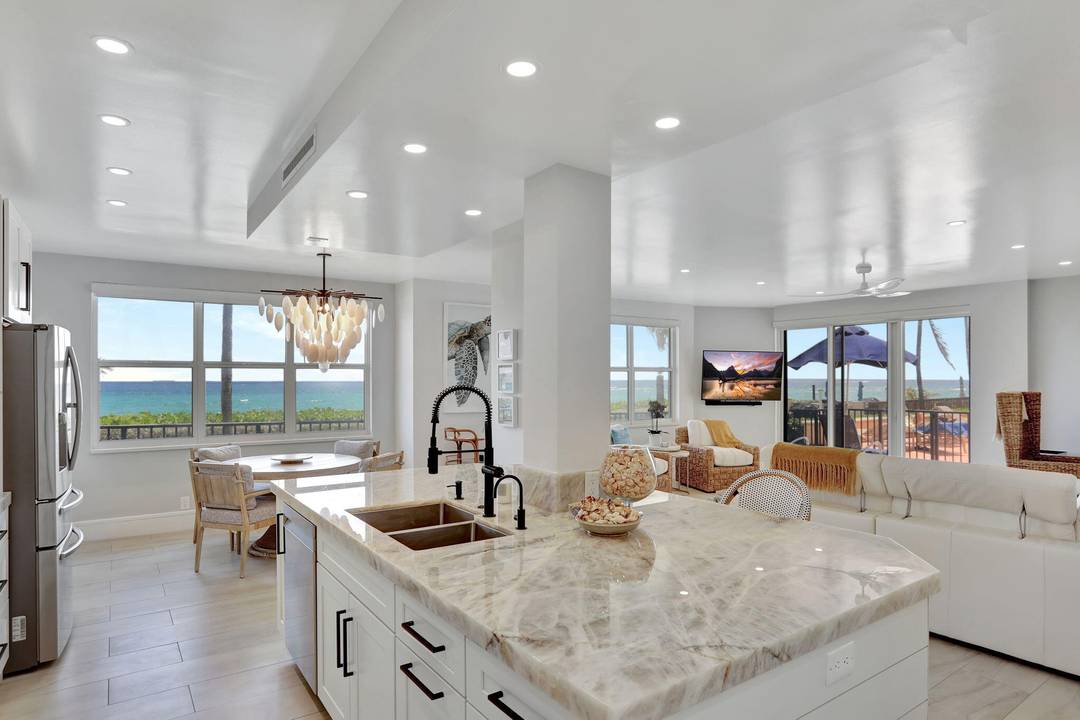 Step into PARADISE, ONE OF A KIND, RARELY AVAILABLE CONDO on the SOUTHEAST CORNER Offering Unparalleled Panoramic Views of the Atlantic Ocean.