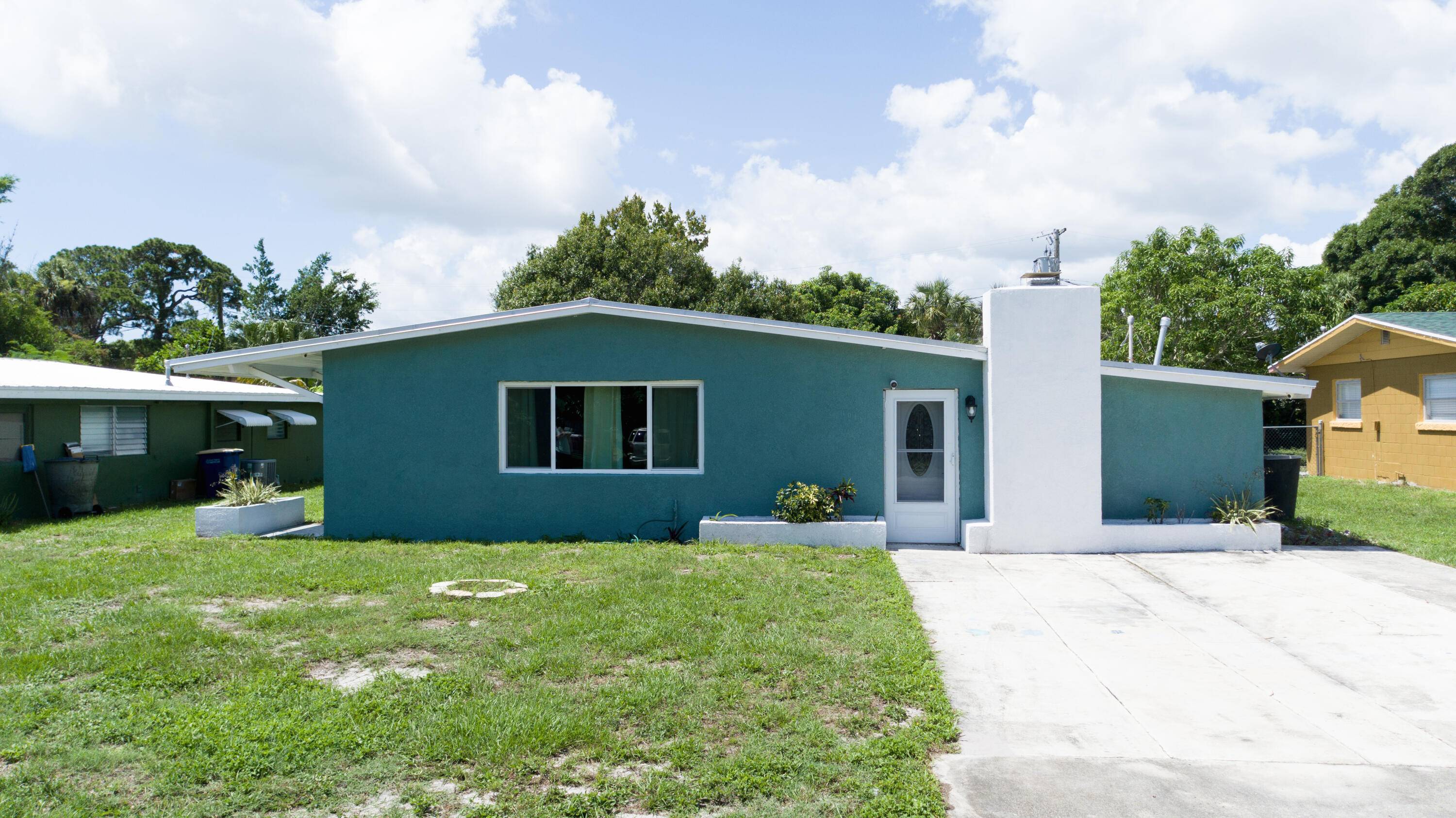 This 3 bed, 2 bath concrete block home in Fort Pierce, FL, has been updated with a 2012 metal roof and a fully tiled interior.