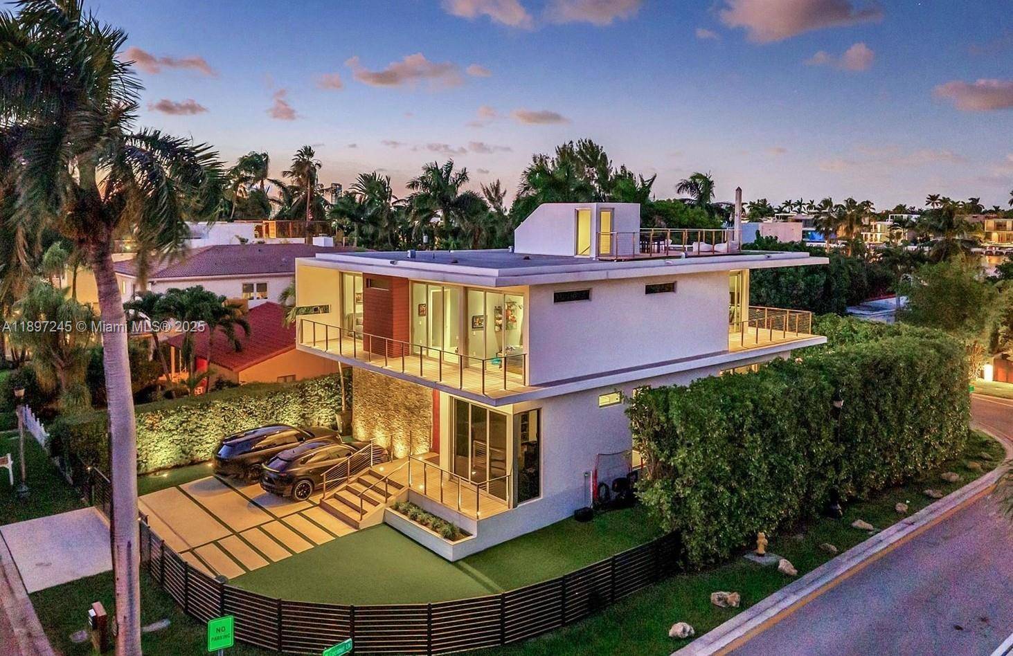 Modern architectural gem on exclusive gated Palm Island, this home blends warm natural finishes with bold contemporary design.