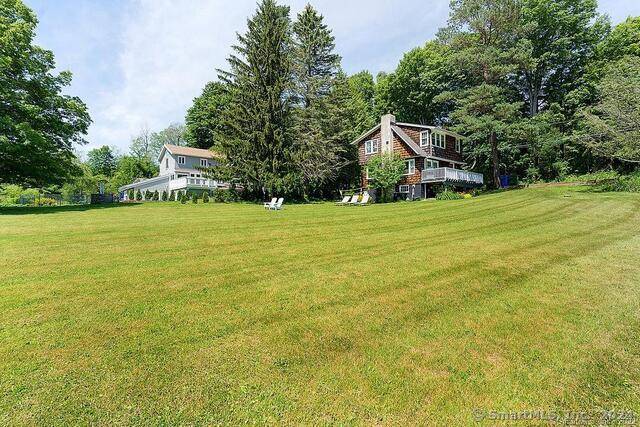 Pristine 1920's barn style 4 bedroom 4 bath home with separate 1 bedroom cottage set on 20 open acres with a stream, ponds heated pool and tennis court.
