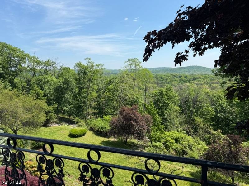 Unsurpassed elegance and panoramic mountain views describe this unique custom built and meticulously renovated home set back on 1.