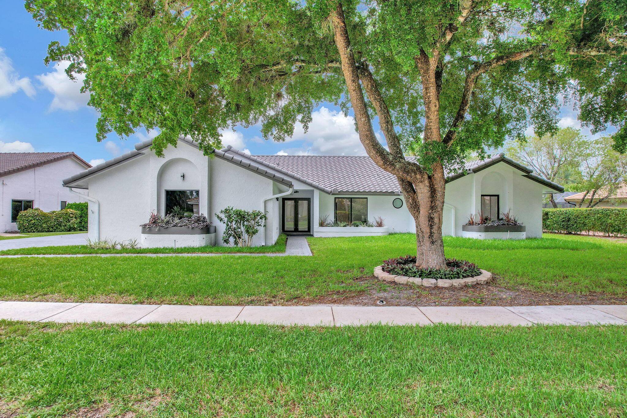 Move right into a FULLY renovated 4 bedroom 3 bath office pool home in Boca Woods Country Club.