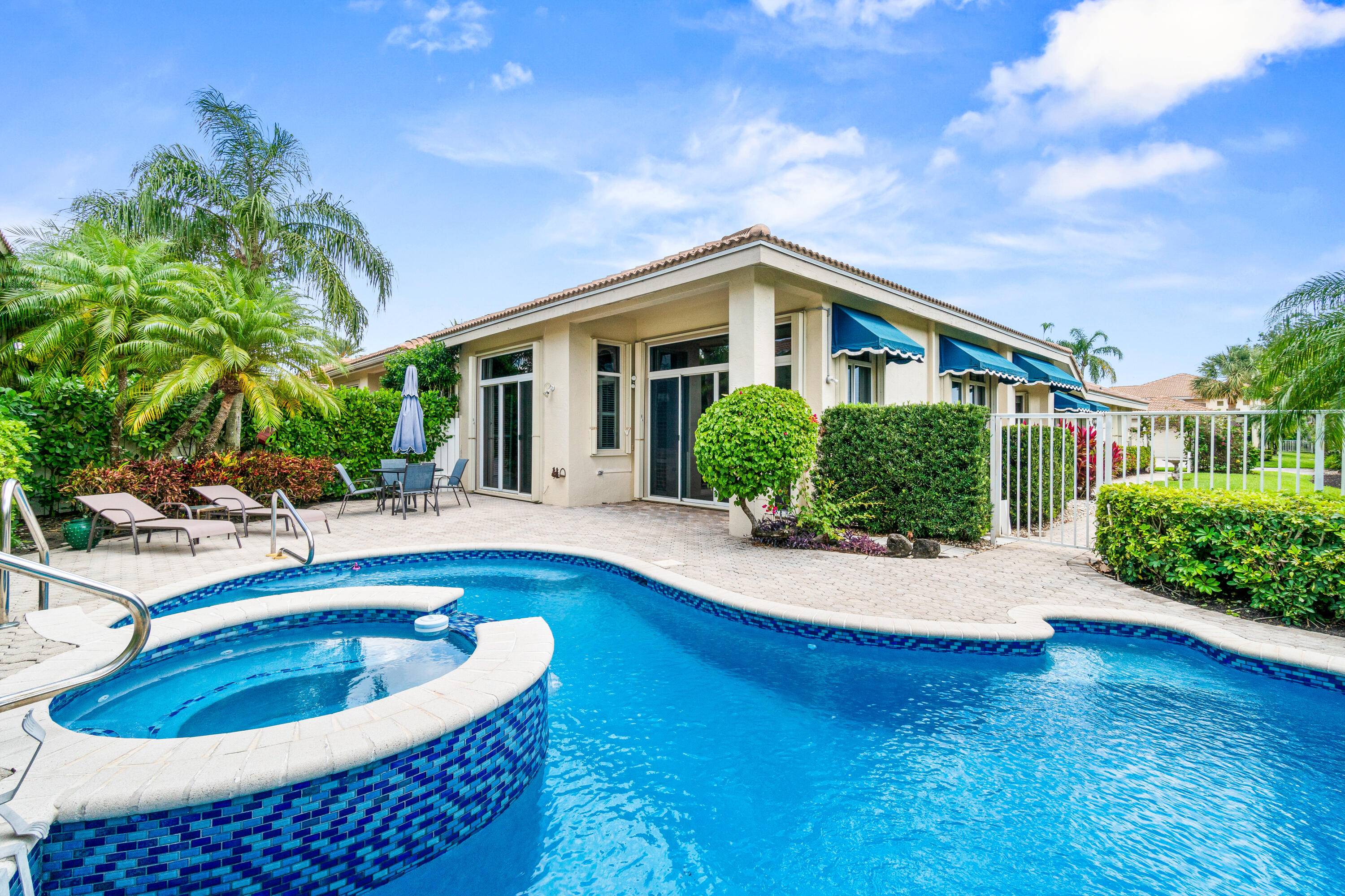Step into this beautiful one story townhome, where natural light floods the spacious living room through large windows adorned with elegant plantation shutters and sliding glass doors that open to ...