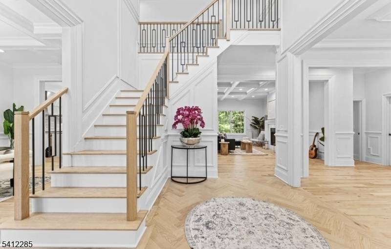 Nestled on an expansive lot exceeding half an acre in the sought after Riker Hill neighborhood, this new construction 5 bedroom, 5.