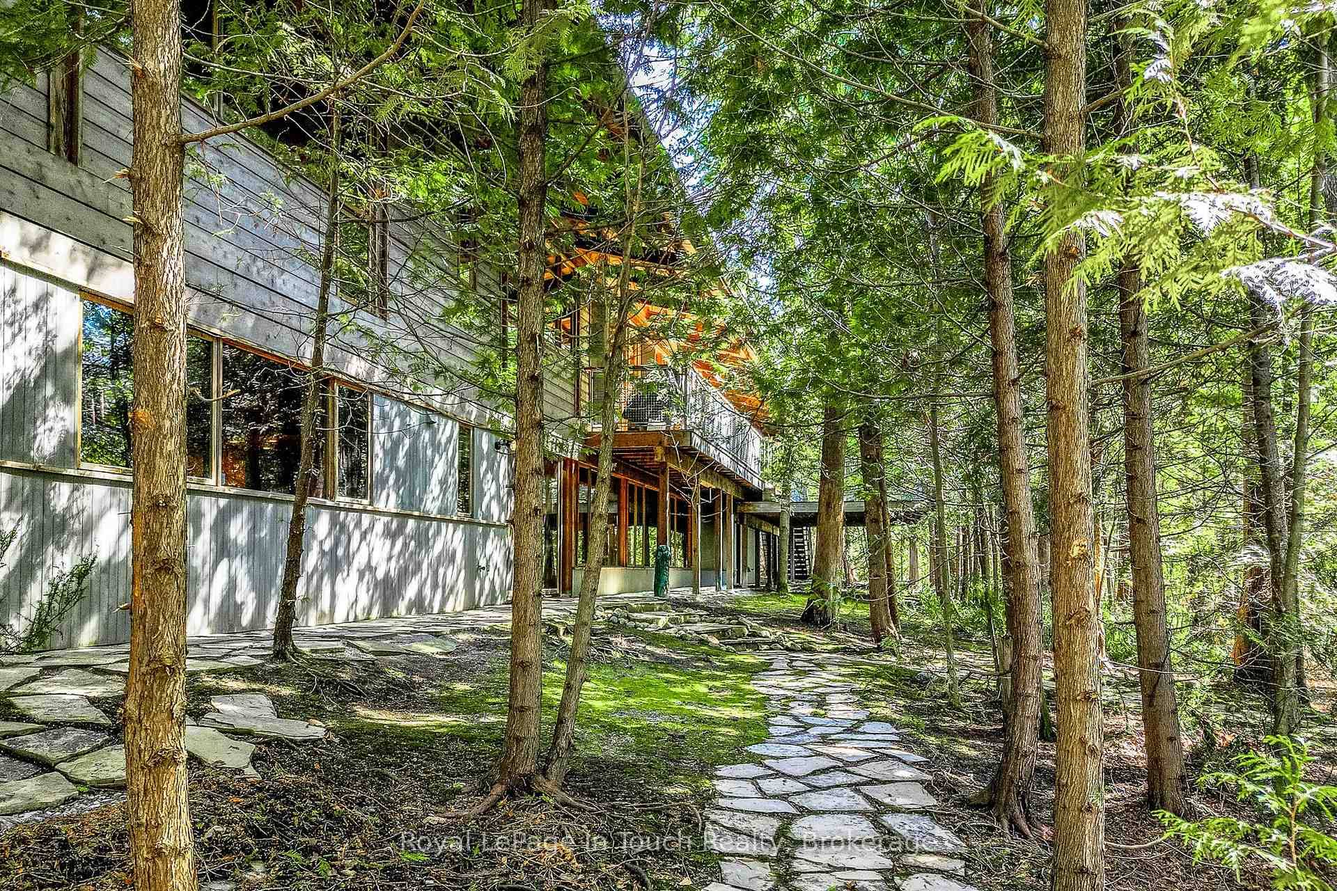 Nestled within the exclusive Cedar Ridge community in Tiny Township, this architect designed retreat offers a rare opportunity to own a custom waterfront home.
