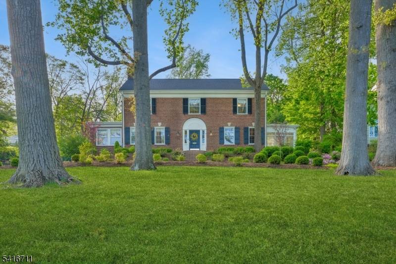 Exceptional all brick Georgian Colonial home set in the heart of Maplewood amidst tall trees and specimen plantings on over 1 3 acre.
