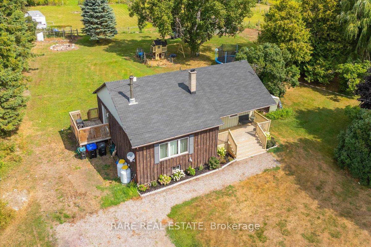 Nestled on a breathtaking 5 acre property in the heart of New Lowell, this charming 3 2 bedroom bungalow offers the perfect blend of comfort, function, and country beauty.