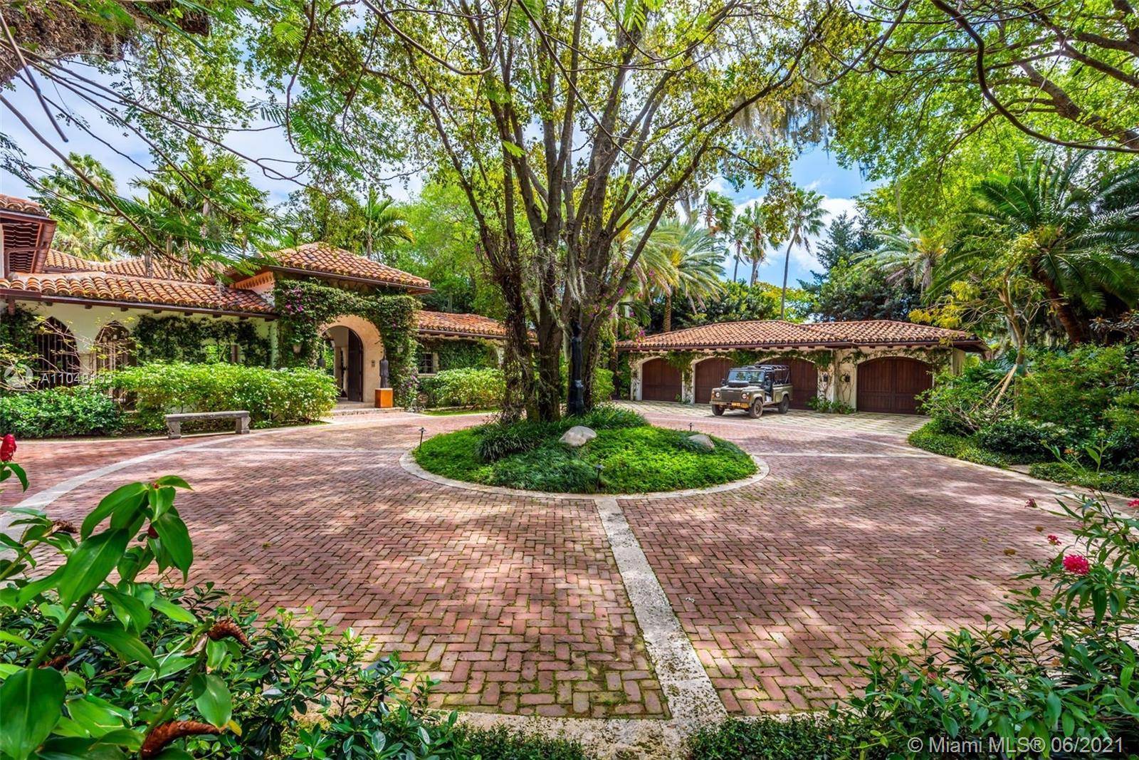 This Mediterranean Estate features 175' of direct waterfront overlooking scenic Indian Creek ideally situated on a rarely offered 1.